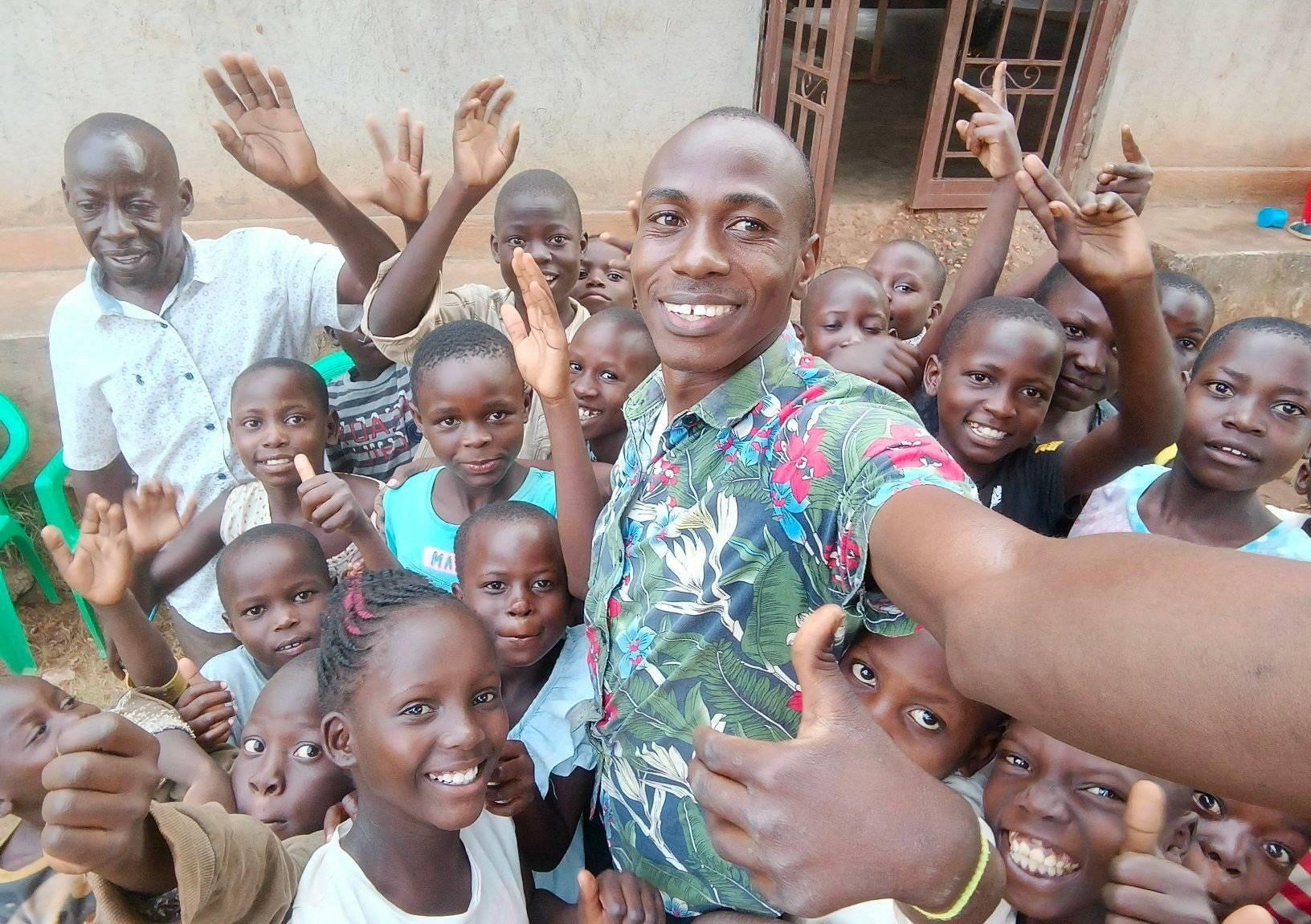 Pastor Dwallo, Pastor Isaac and children at Great Love Junior Academy