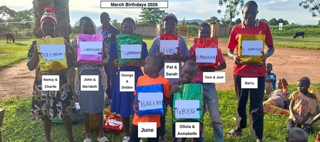The March birthday children holding their gifts