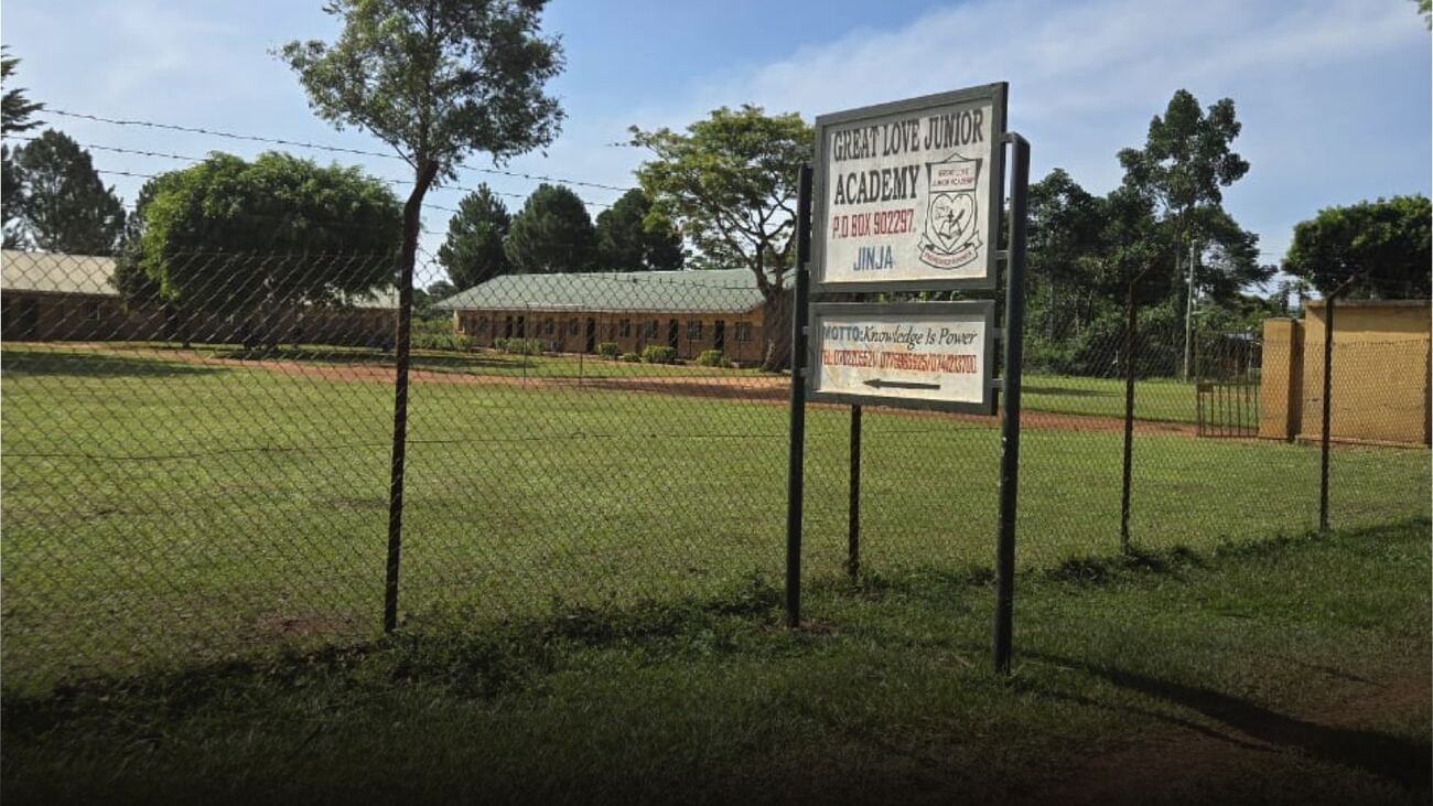 The school grounds today, with the Great Love Junior Academy sign at the gate
