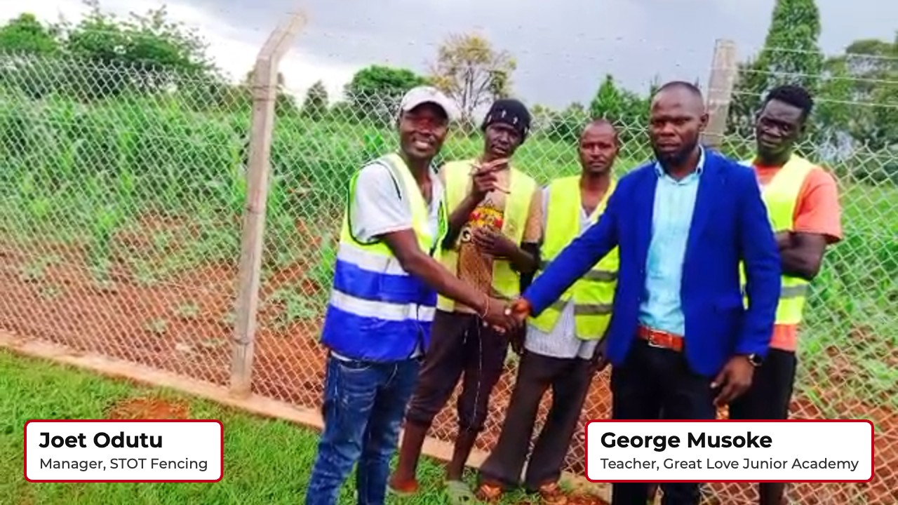 Joet Odutu of STOT Fencing and George Musoke shaking hands at the finished fence