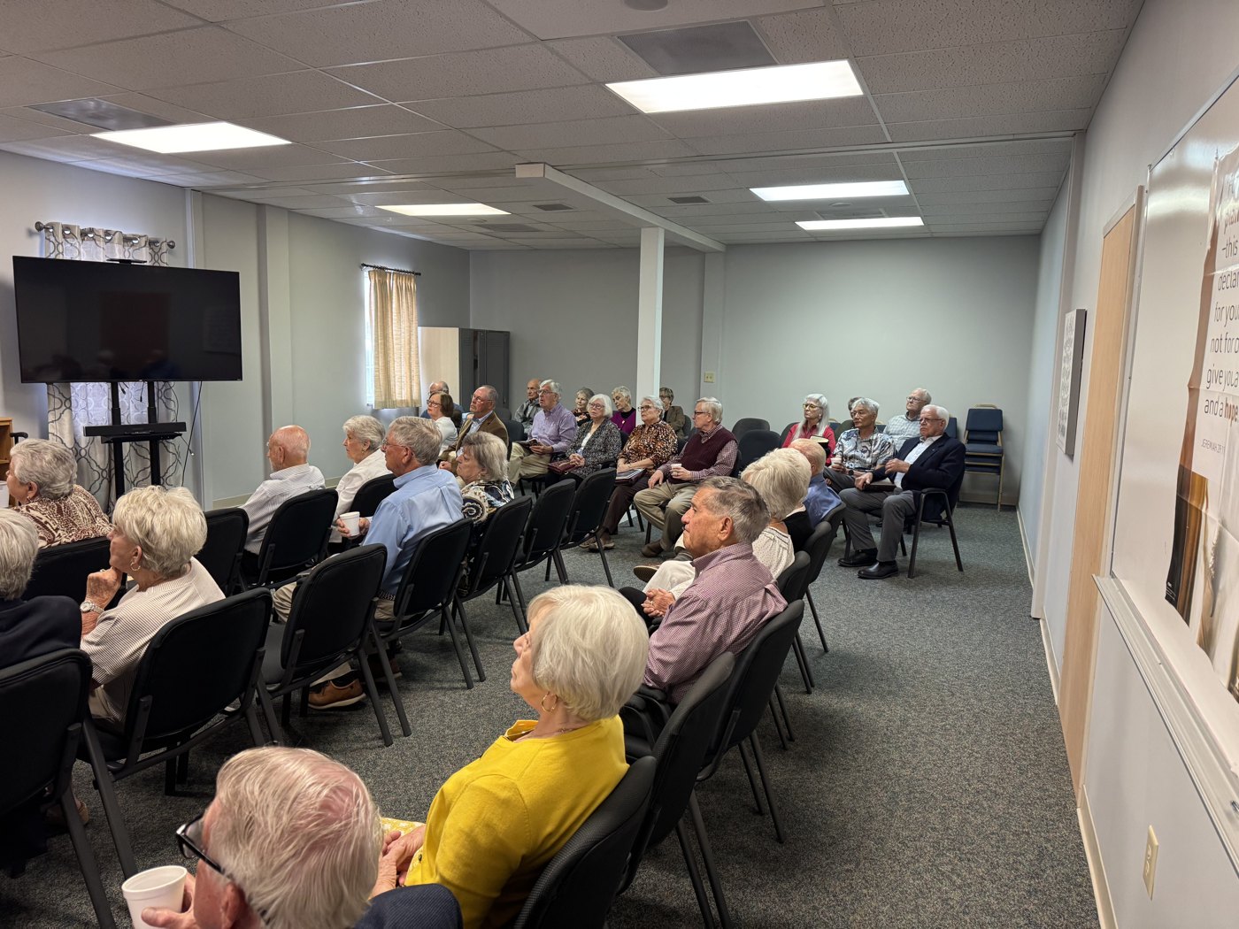 Members of the Empty Nesters class seated and listening, seen from the side