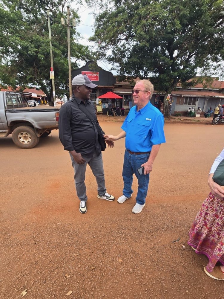 Enock Nkulanga on a red dirt road in Uganda
