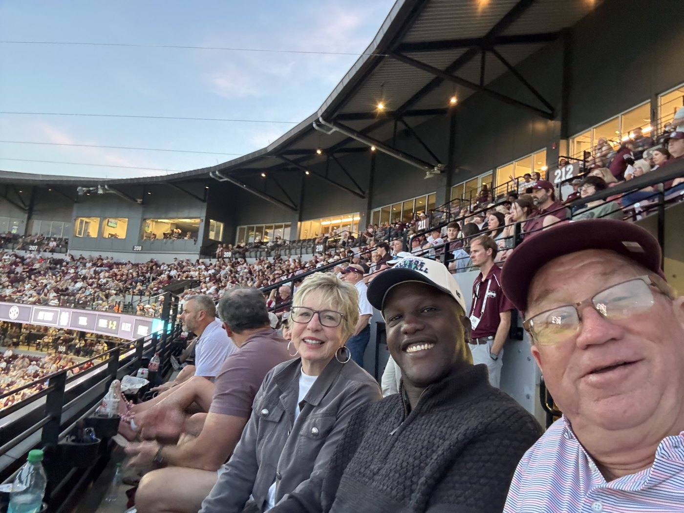 Enock at a baseball game with his hosts