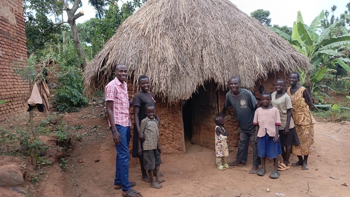 The family outside their old mud house