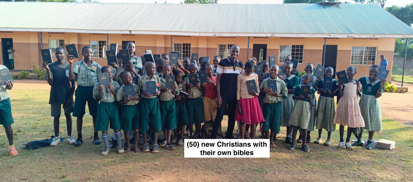 Fifty new Christians holding their own Bibles